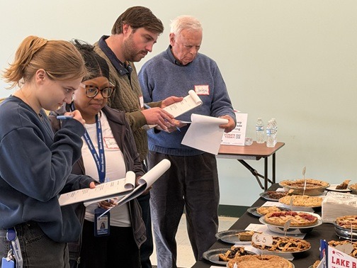 Pie baking contest judges comparing notes