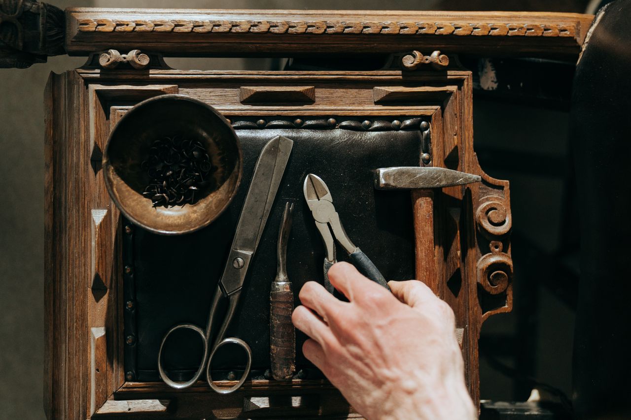 Home A selection of vintage tools on a wooden table, perfect for renovation and crafts.